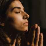 close up shot of a woman praying